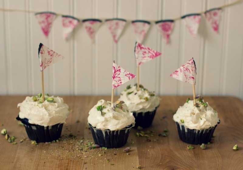 chocolate olive oil cupcakes with goat cheese frosting and pistachios