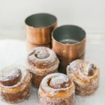 cardamom sugar buns next to copper molds