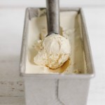 coffee ice cream in a tin pan with ice cream scoop