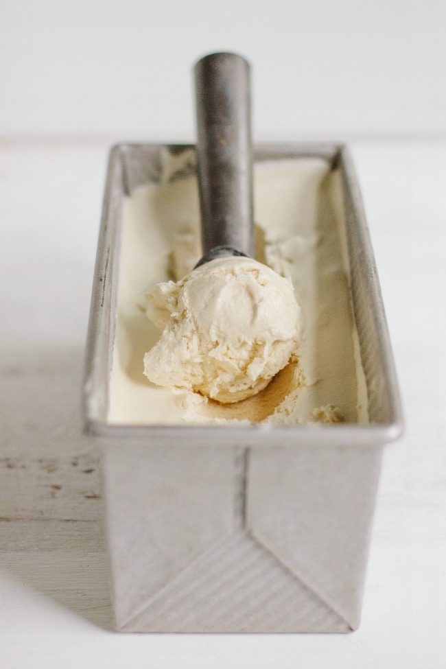 coffee ice cream in a tin pan with ice cream scoop