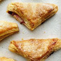 sour cherry turnovers on parchment paper
