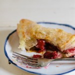 sour cherry turnovers on white enamel plate