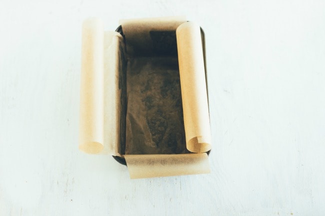 A loaf pan lined with parchment paper