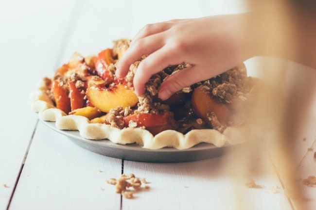 Placing Crumble Topping on Peach Pie | Sarah Kieffer | The Vanilla Bean Blog