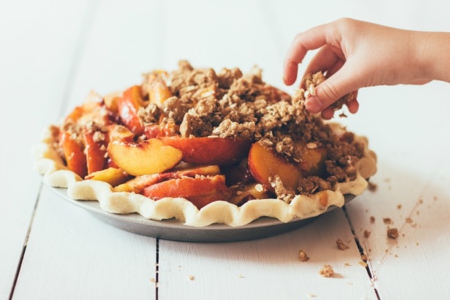 Placing Crumble Topping on Peach Pie | Sarah Kieffer | The Vanilla Bean Blog