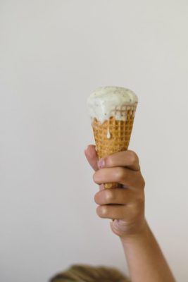 holding a sugar cone with mint ice cream