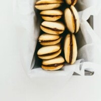 homemade milano cookies in an aluminum tin