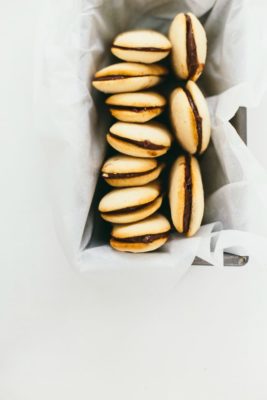 homemade milano cookies in an aluminum tin