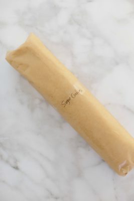 A roll of sugar cookie dough wrapped in parchment