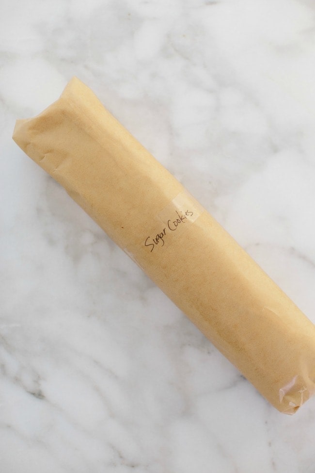 A roll of cookie dough wrapped in parchment.