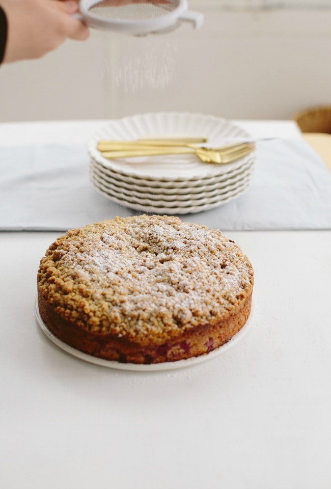 sprinkling powdered sugar on coffee cake