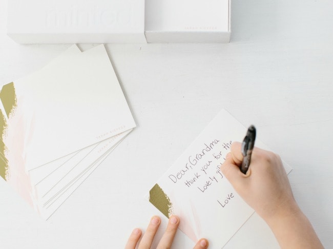 A child writing a letter to their grandma