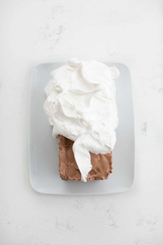 chocolate ice cream cake being topped with mint meringue | The Vanilla Bean Blog