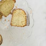 lemon poppy seed bundt cake on glass cake stand