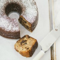 banana chocolate chip bundt cake with slice cut out of it