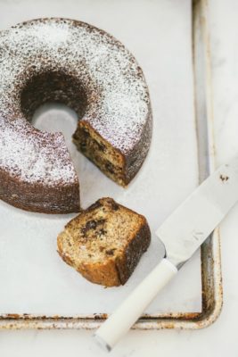 banana chocolate chip bundt cake with slice cut out of it