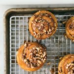 caramel rolls on a wire cooling rack