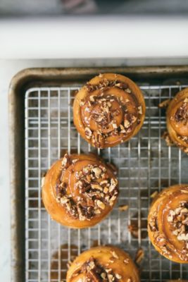 caramel rolls on a wire cooling rack