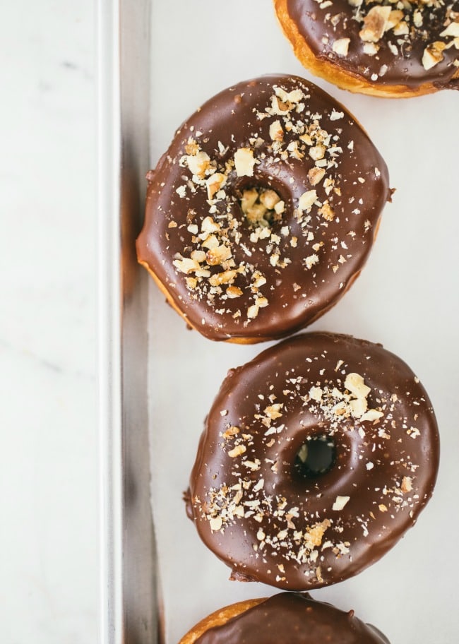 Raised Donuts with Chocolate Glaze and Candied Walnuts