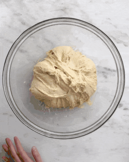 video of folding cinnamon roll dough.