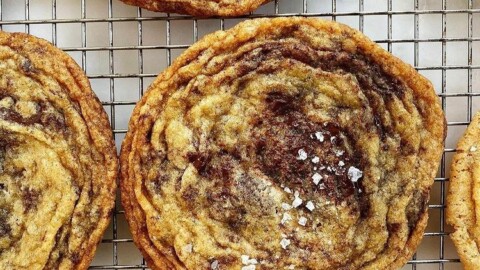 pan banging chocolate chip cookies on wire cooling rack