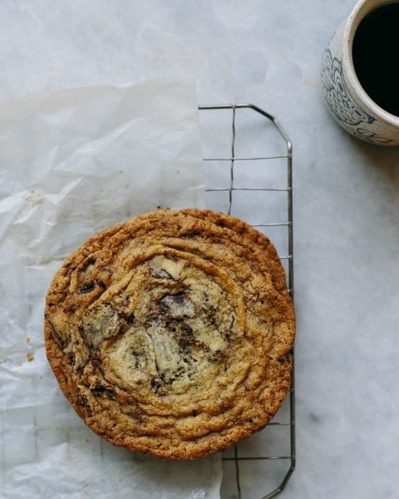pan-banging chocolate chip cookies on parchment and wire rack