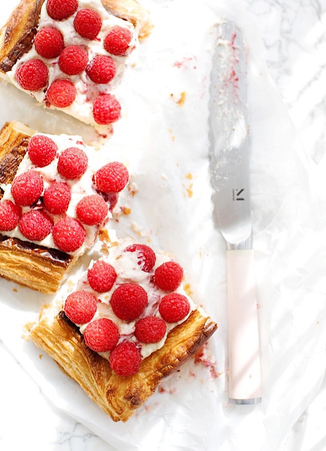 squares of Raspberry Puff Pastry Tart, next to a knife.