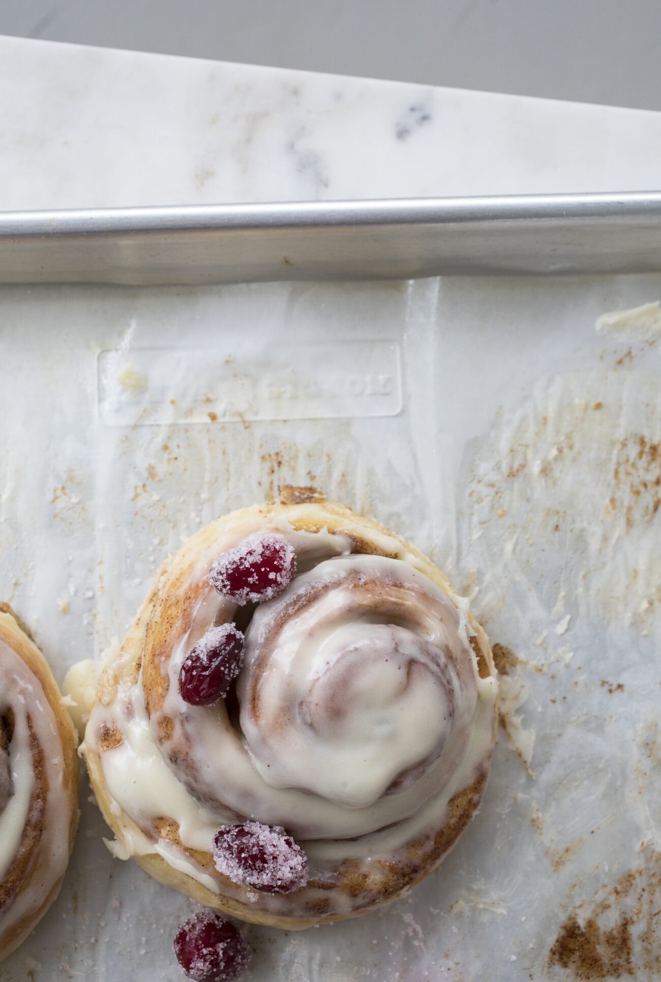 Cinnamon roll on baking sheet with parchment paper