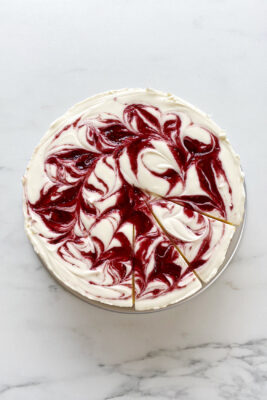 no bake cheesecake with jam swirl, sitting on marble