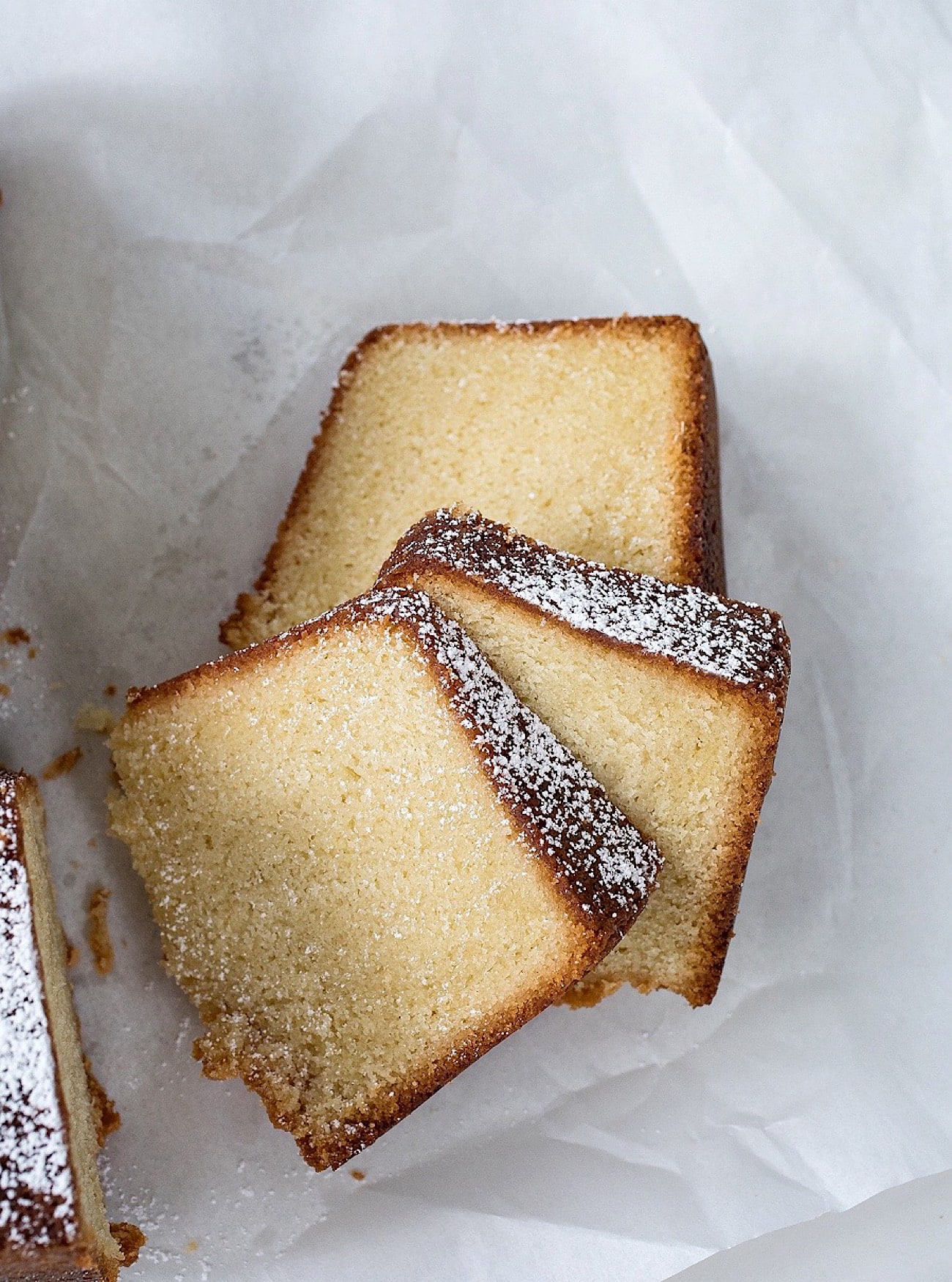 vanilla bundt cake sliced, on parchment