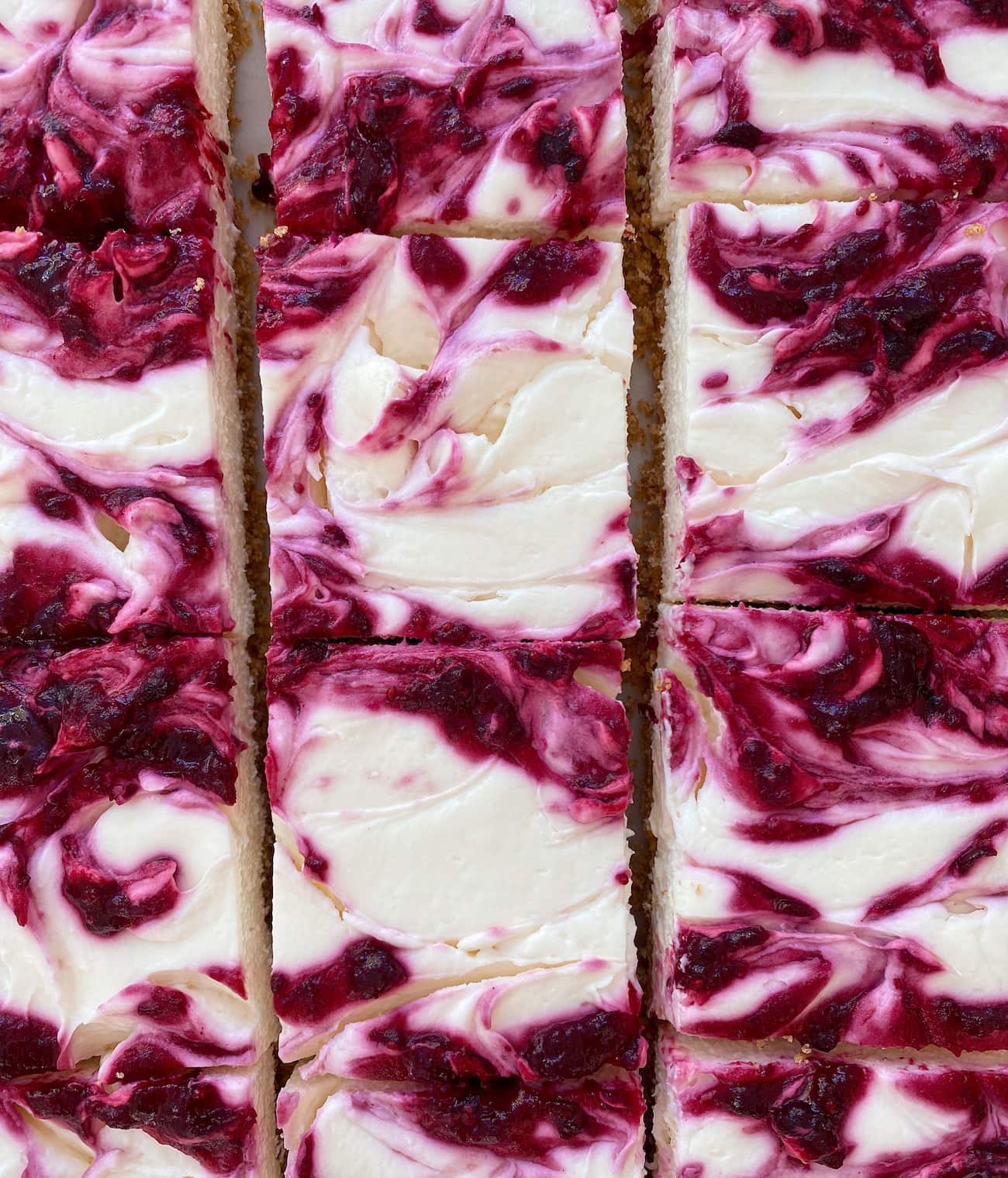 no bake cheesecake bars with cranberry swirl, cut into squares