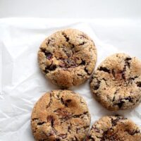 Rye chocolate chunk cookies on parchment paper