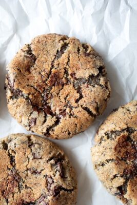 cranberry rye chocolate chunk cookies on parchment paper