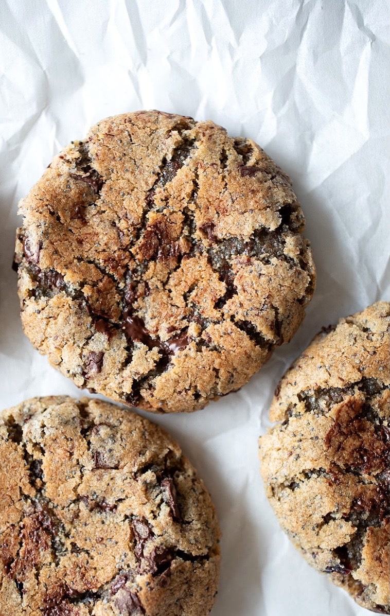 cranberry rye chocolate chunk cookies on parchment paper