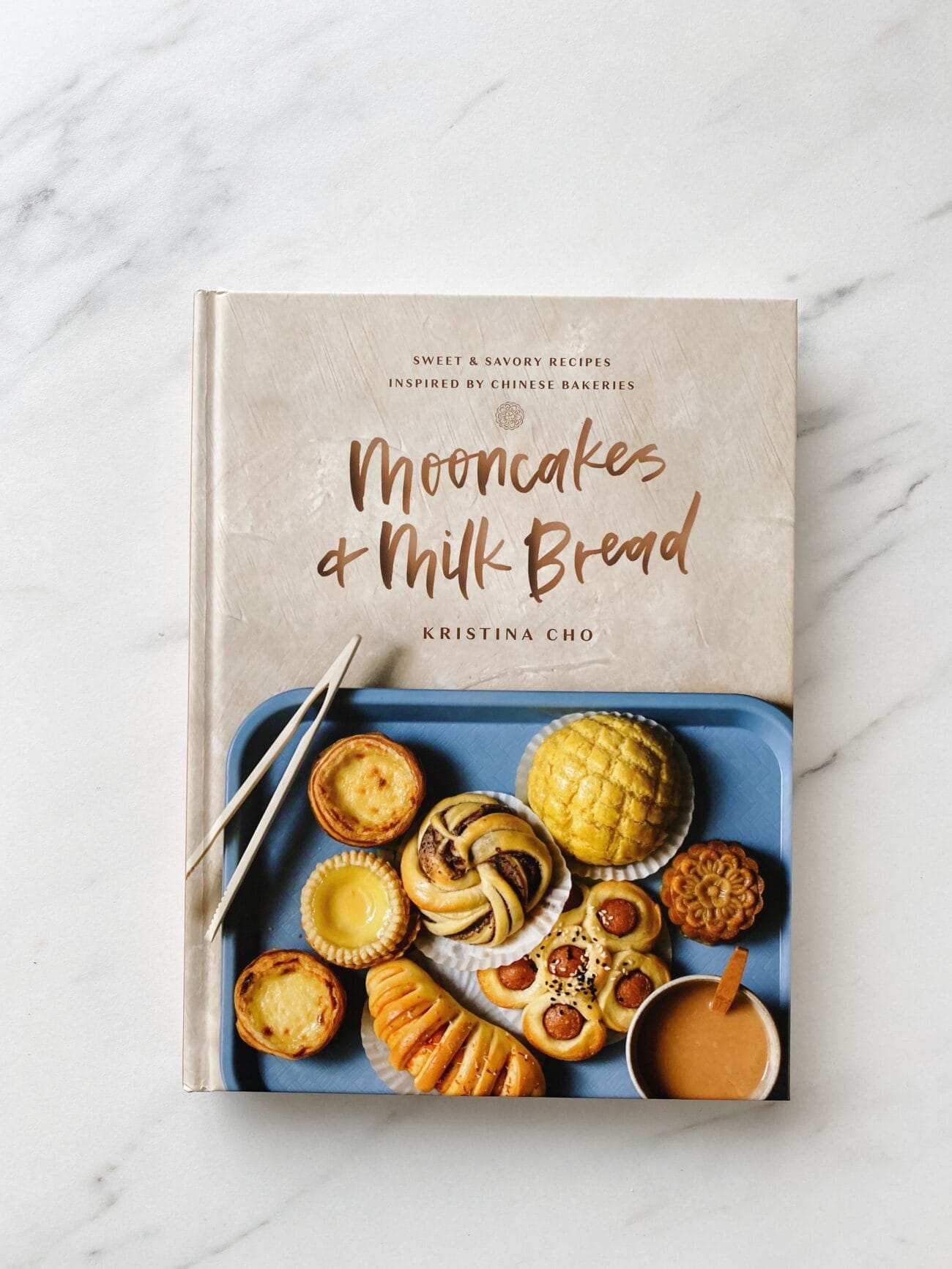 Mooncakes and Milk Bread cookbook on a marble surface