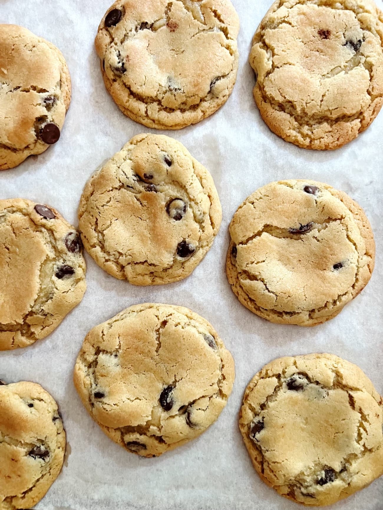 perfect chocolate chip cookies on parchment paper