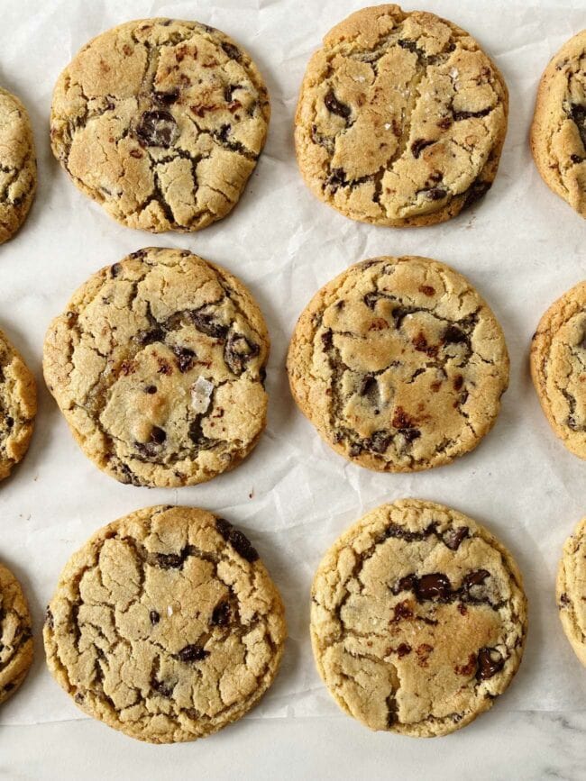 chocolate chip cookies on parchment paper in rows