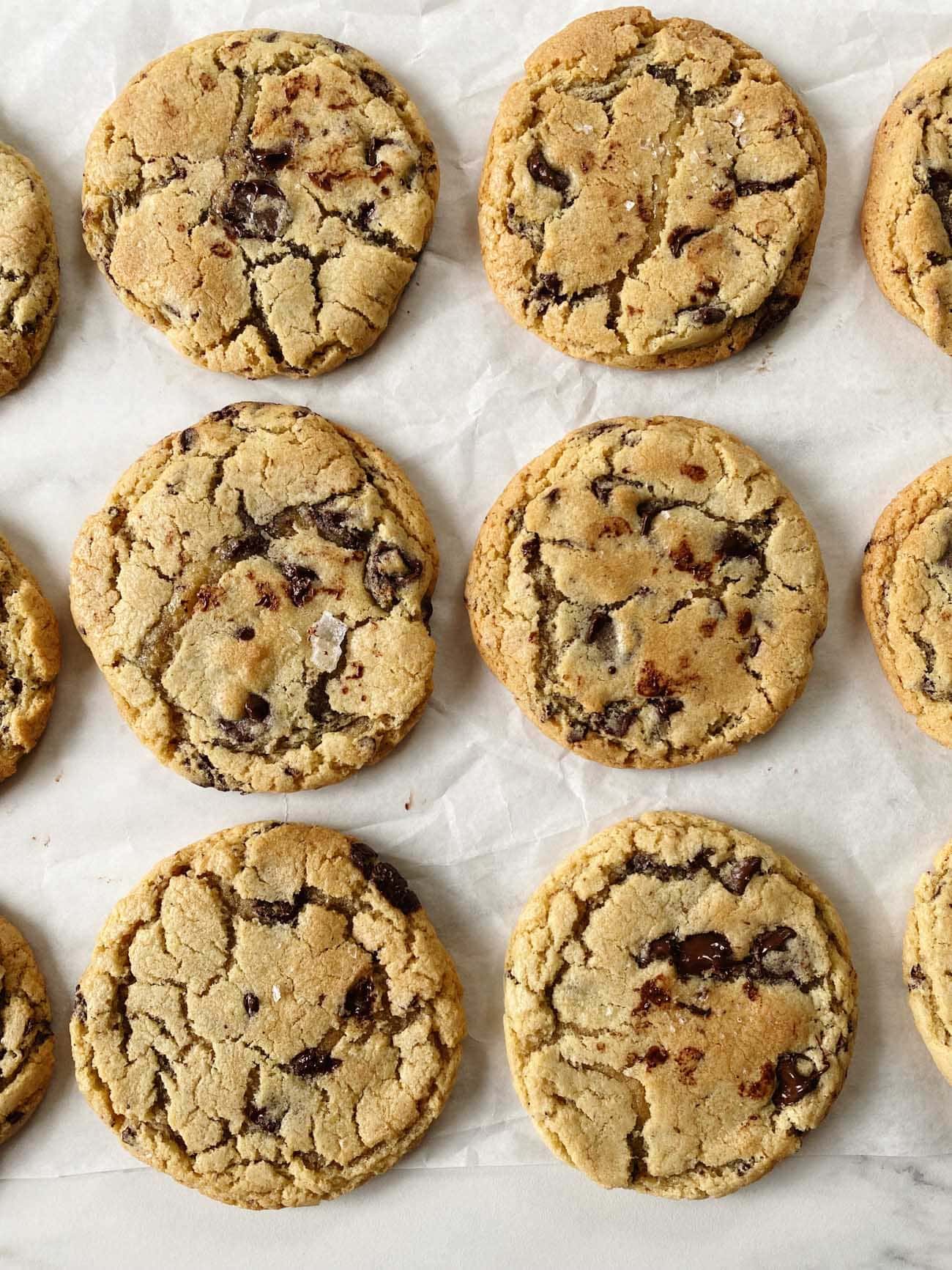 chocolate chip cookies on parchment paper in rows