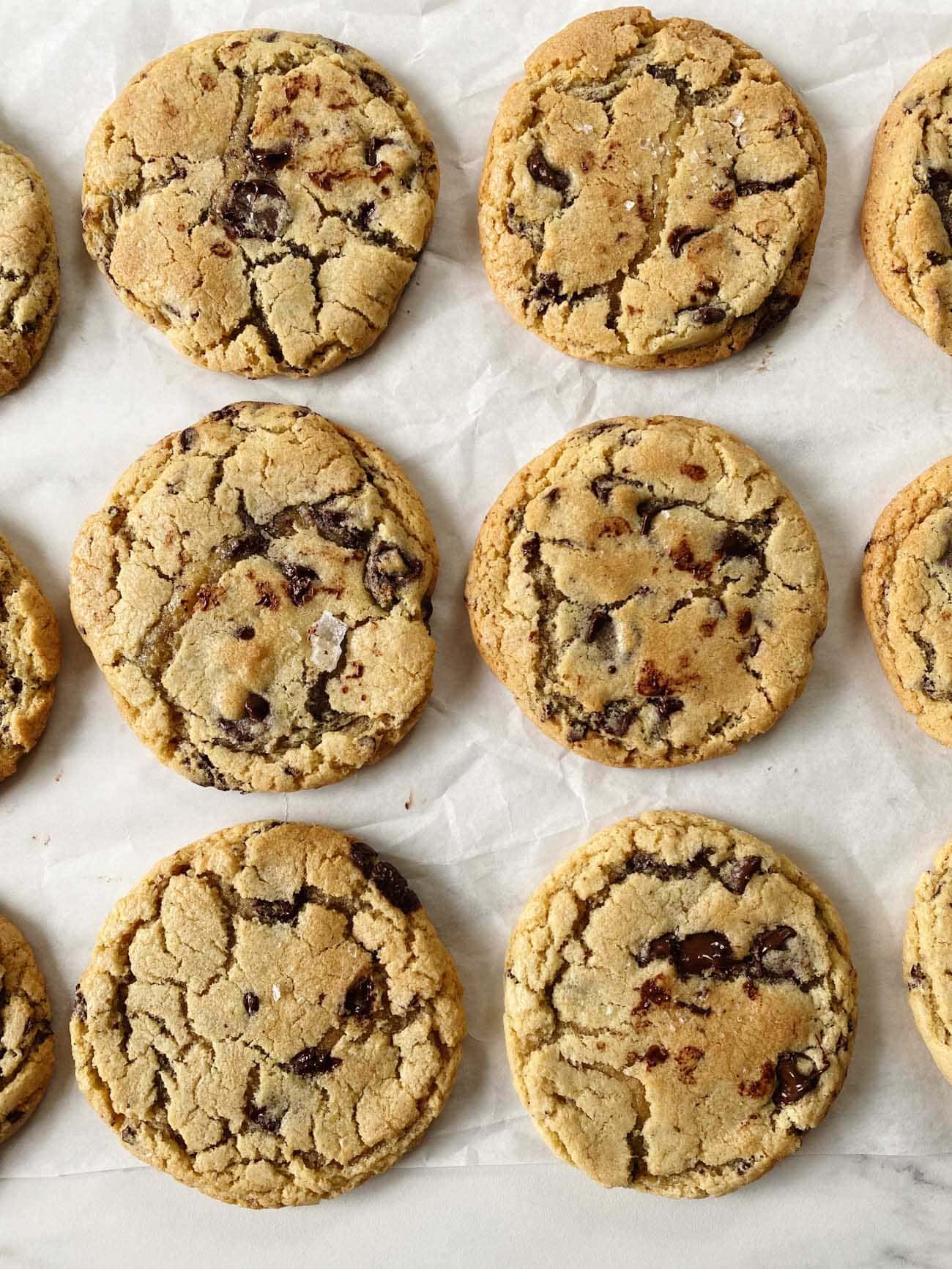 chocolate chip cookies on parchment paper in rows