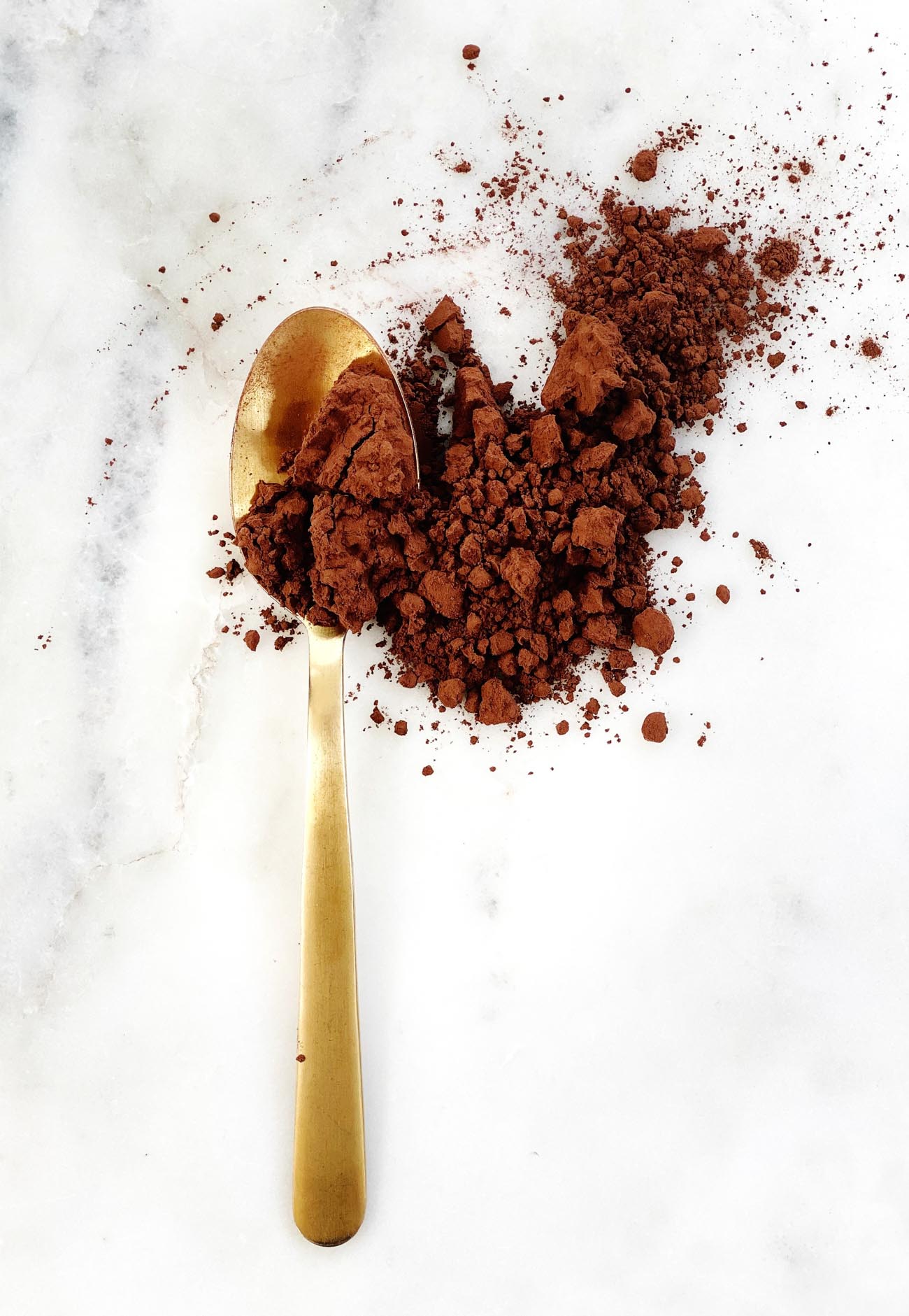 cocoa powder on a gold spoon