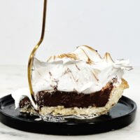 chocolate meringue pie with gold fork in it
