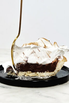 chocolate meringue pie with gold fork in it