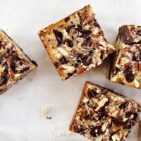 chocolate pecan pie bars on white parchment paper