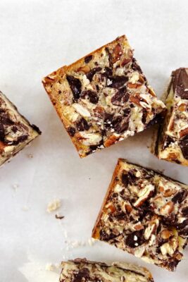 chocolate pecan pie bars on white parchment paper