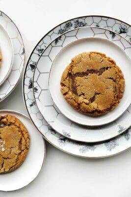 ginger molasses cookies on white and floral plates