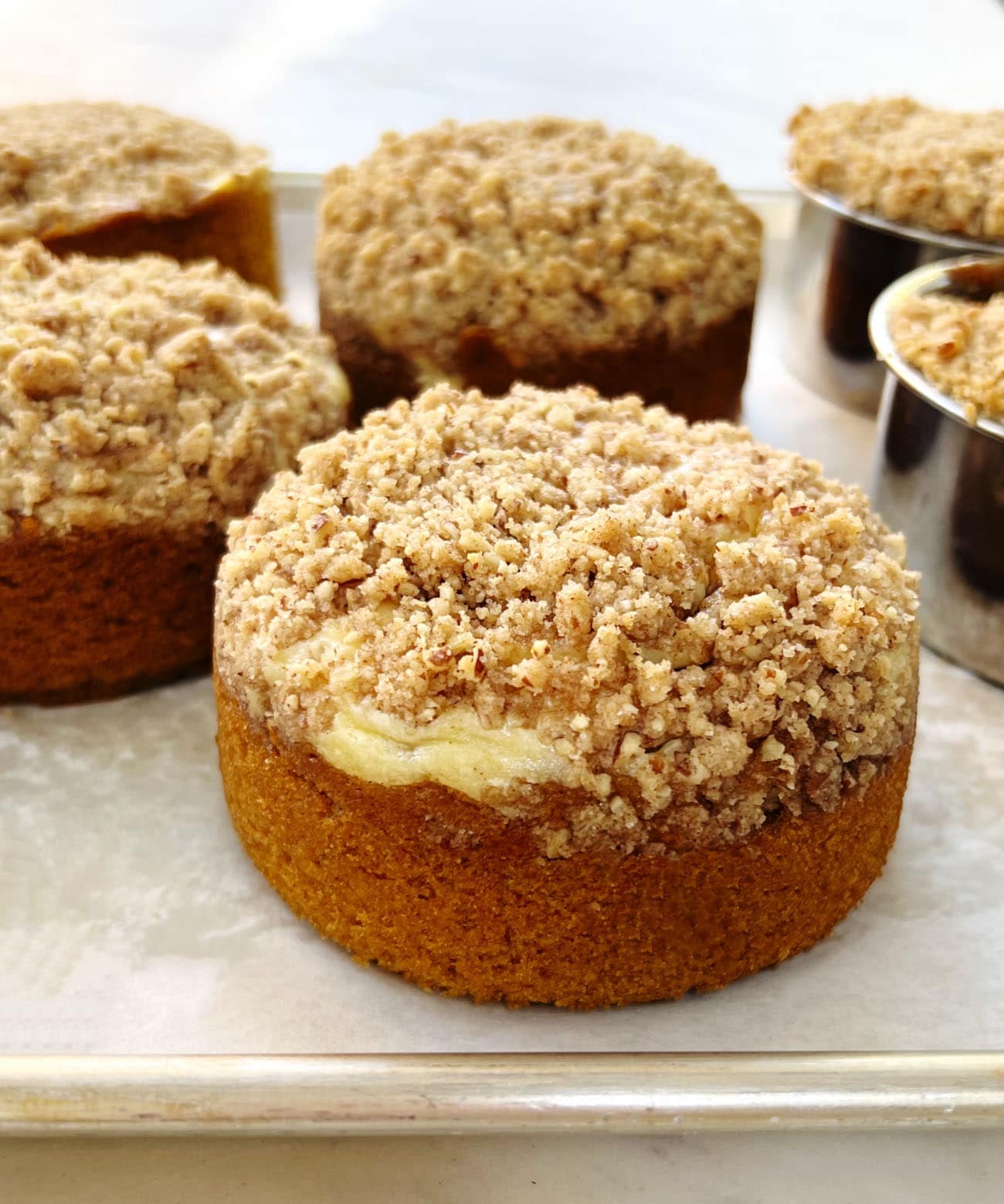 mini pumpkin cakes on a sheet pan