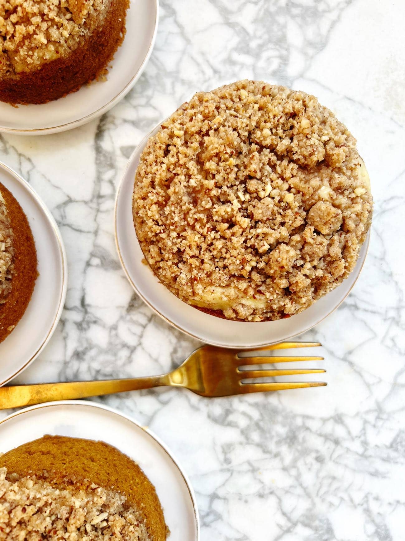 mini pumpkin cakes on a plate with gold fork 