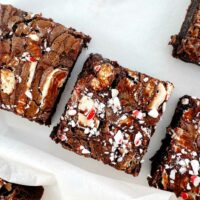 peppermint hot chocolate brownies, cut into squares on white parchment paper