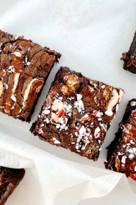 peppermint hot chocolate brownies, cut into squares on white parchment paper