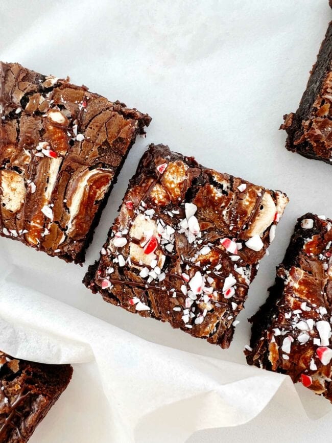 peppermint hot chocolate brownies, cut into squares on white parchment paper